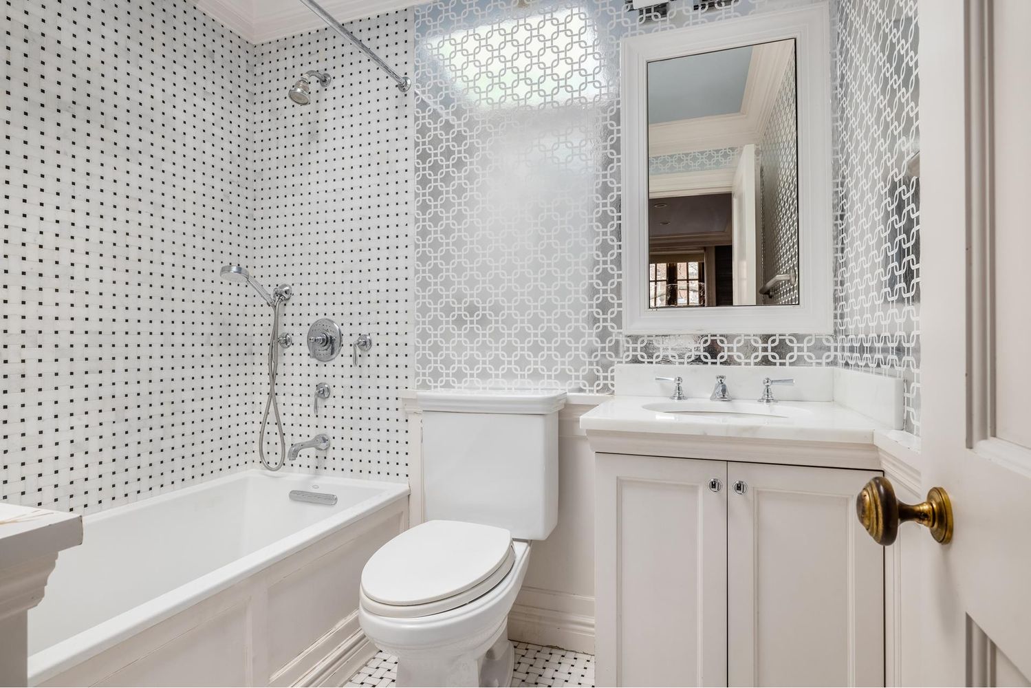 136 East 65th Street Manhattan, NY 10065 - Photo 12 of 20 a bathroom with a sink a toilet and shower