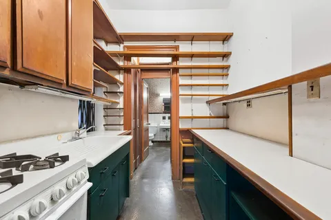 a kitchen with stainless steel appliances a sink and cabinets