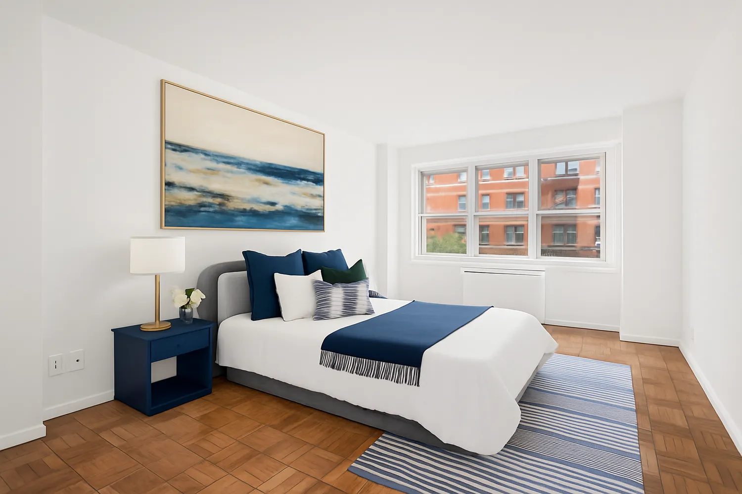 a spacious bedroom with a bed and wooden floor