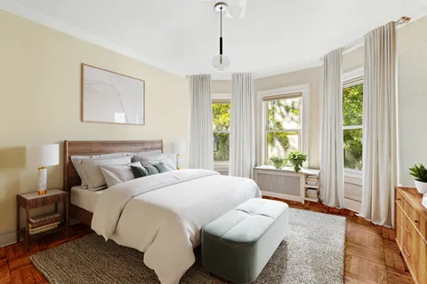 a bedroom with bed and a large window