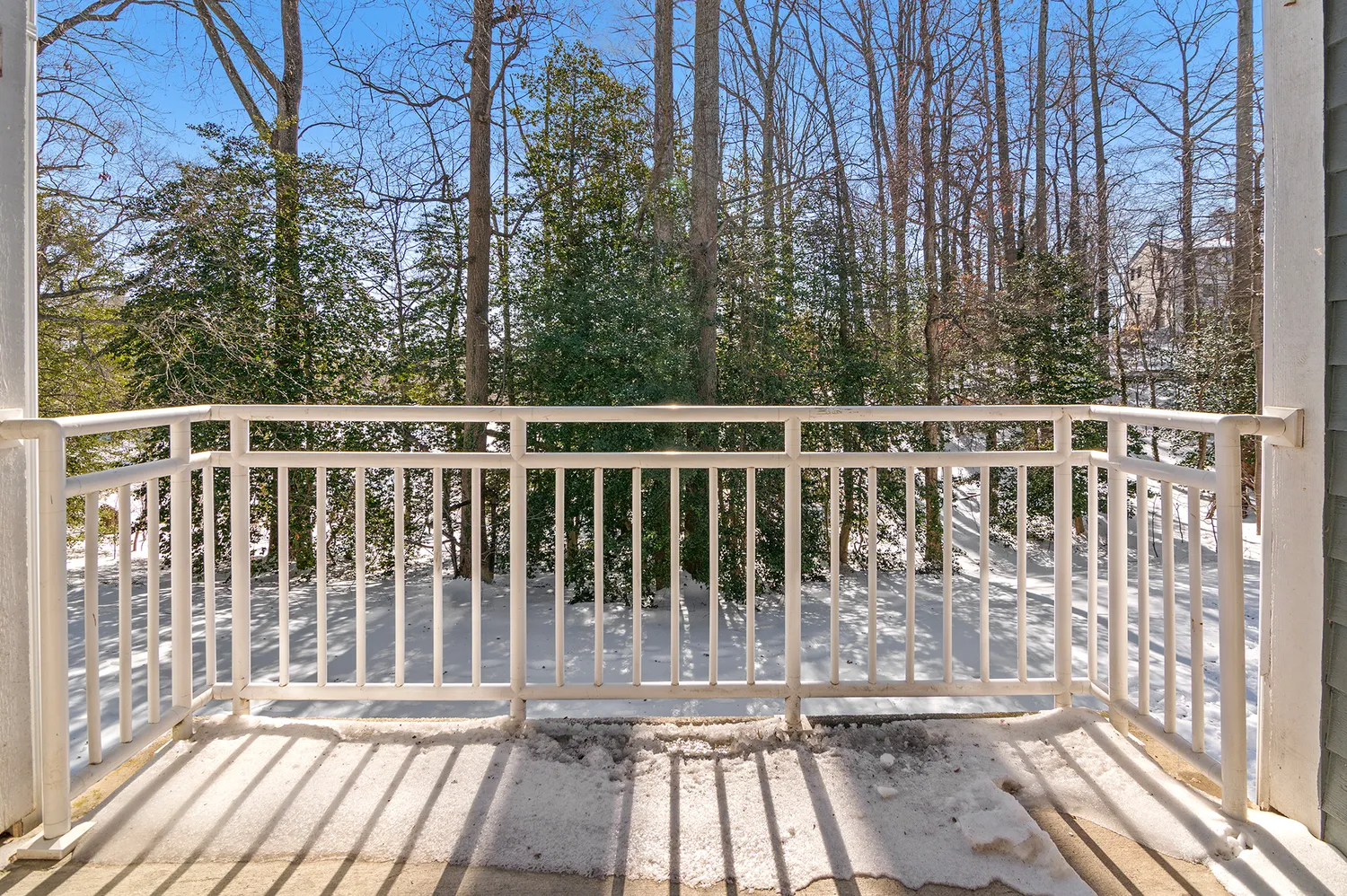 a view of balcony with wooden floor and fence