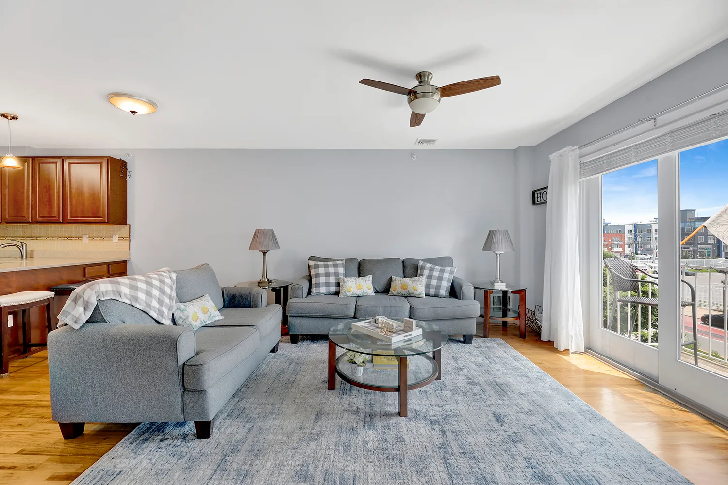 a living room with furniture and a wooden floor