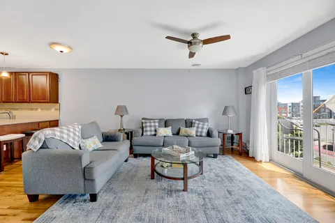 a living room with furniture and a wooden floor