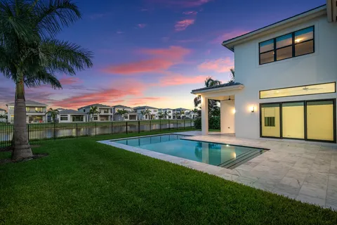 a view of a house with a swimming pool and porch with furniture
