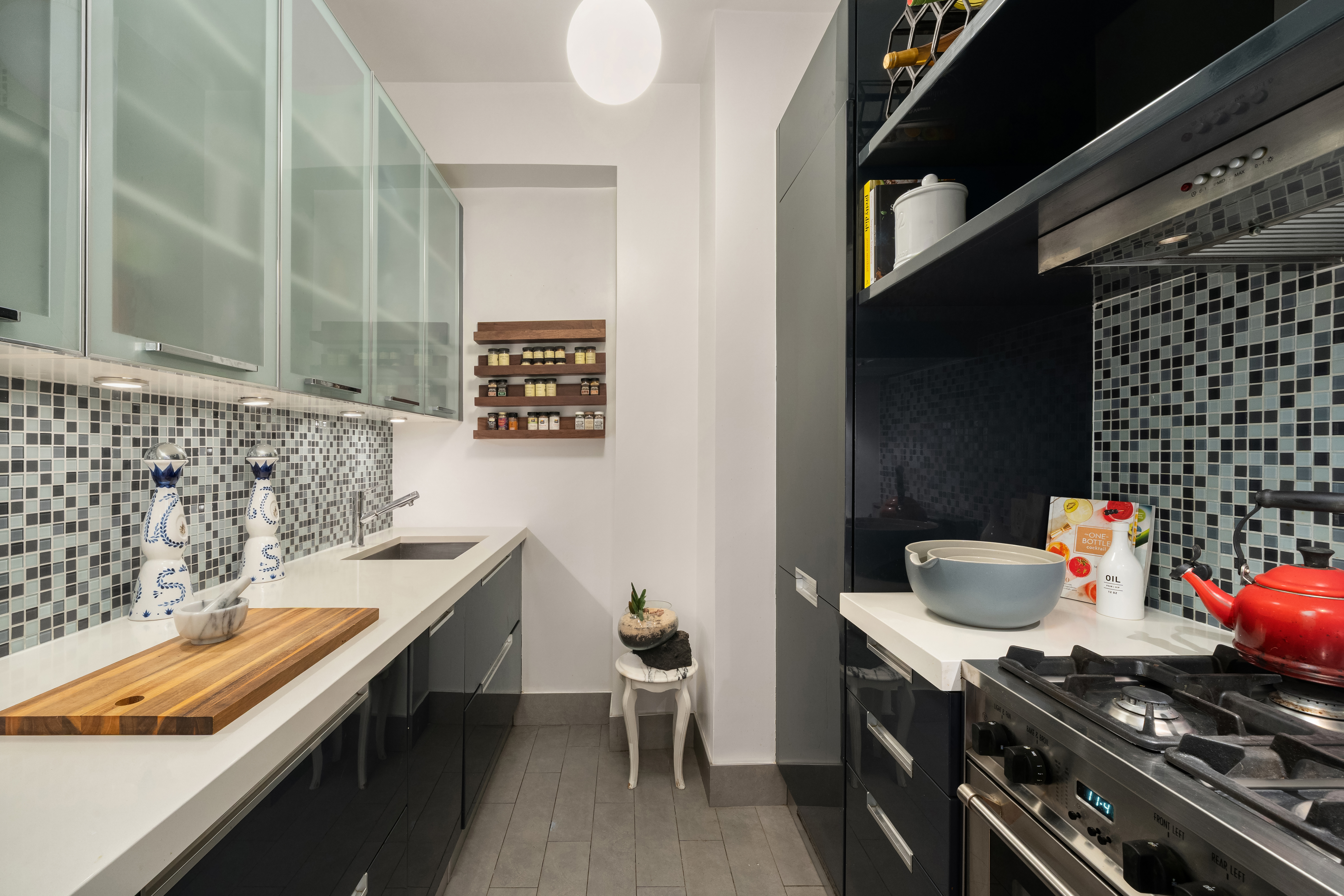 99 Bank Street, Unit 5G Manhattan, NY 10014 - Photo 4 of 9 a kitchen with a sink and a stove top oven
