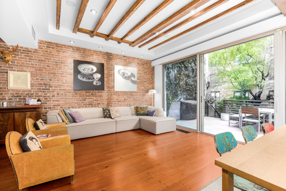 308 West 19th Street, Unit GARDEN Manhattan, NY 10011 - Photo 6 of 18 a living room with furniture and a large window