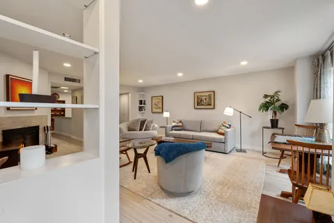 a kitchen with stainless steel appliances kitchen island granite countertop a stove a sink a dining table and chairs