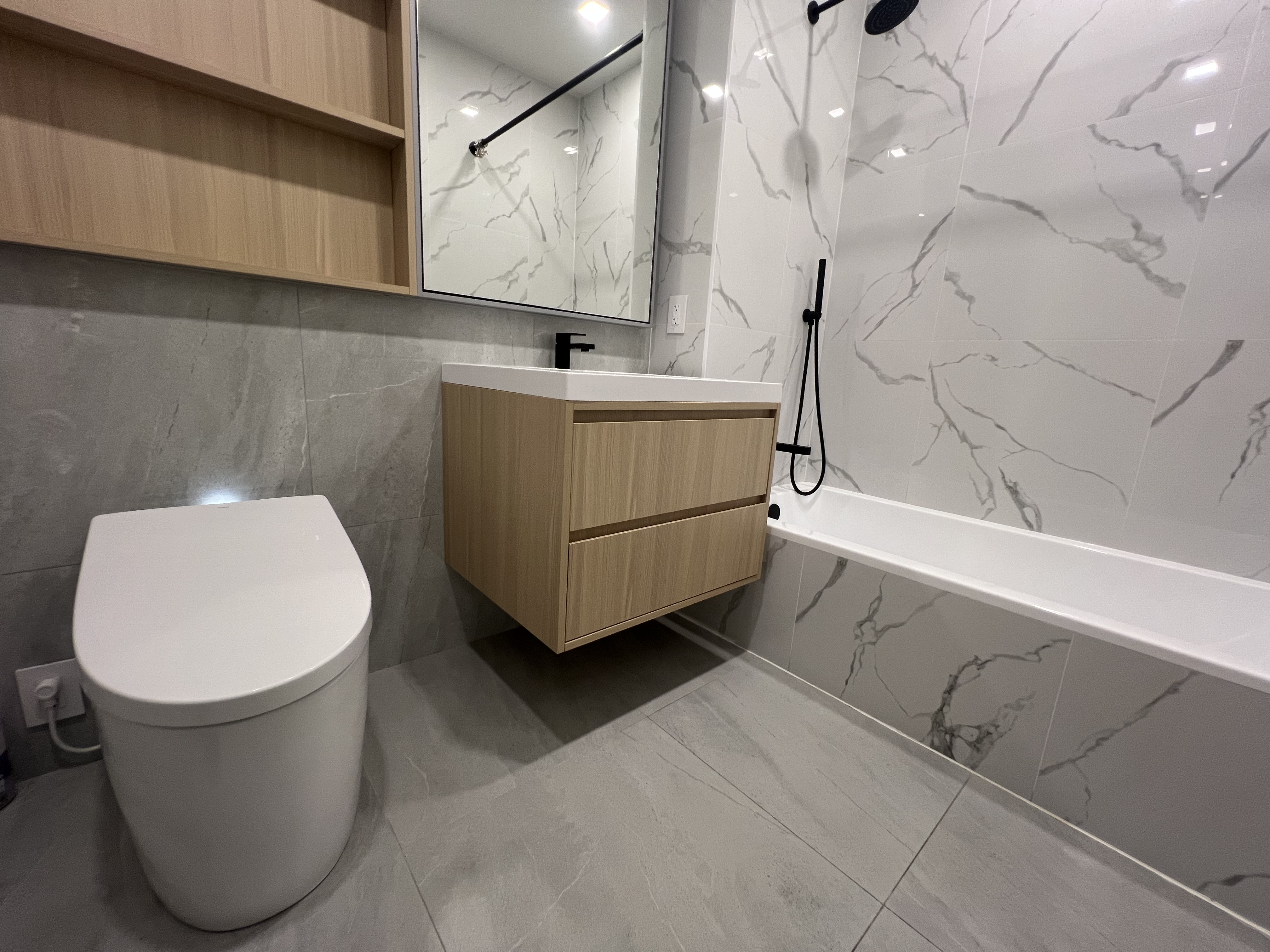 37-34 33rd Street, Unit 7H Queens, NY 11101 - Photo 9 of 18 a bathroom with a sink a toilet and bathtub