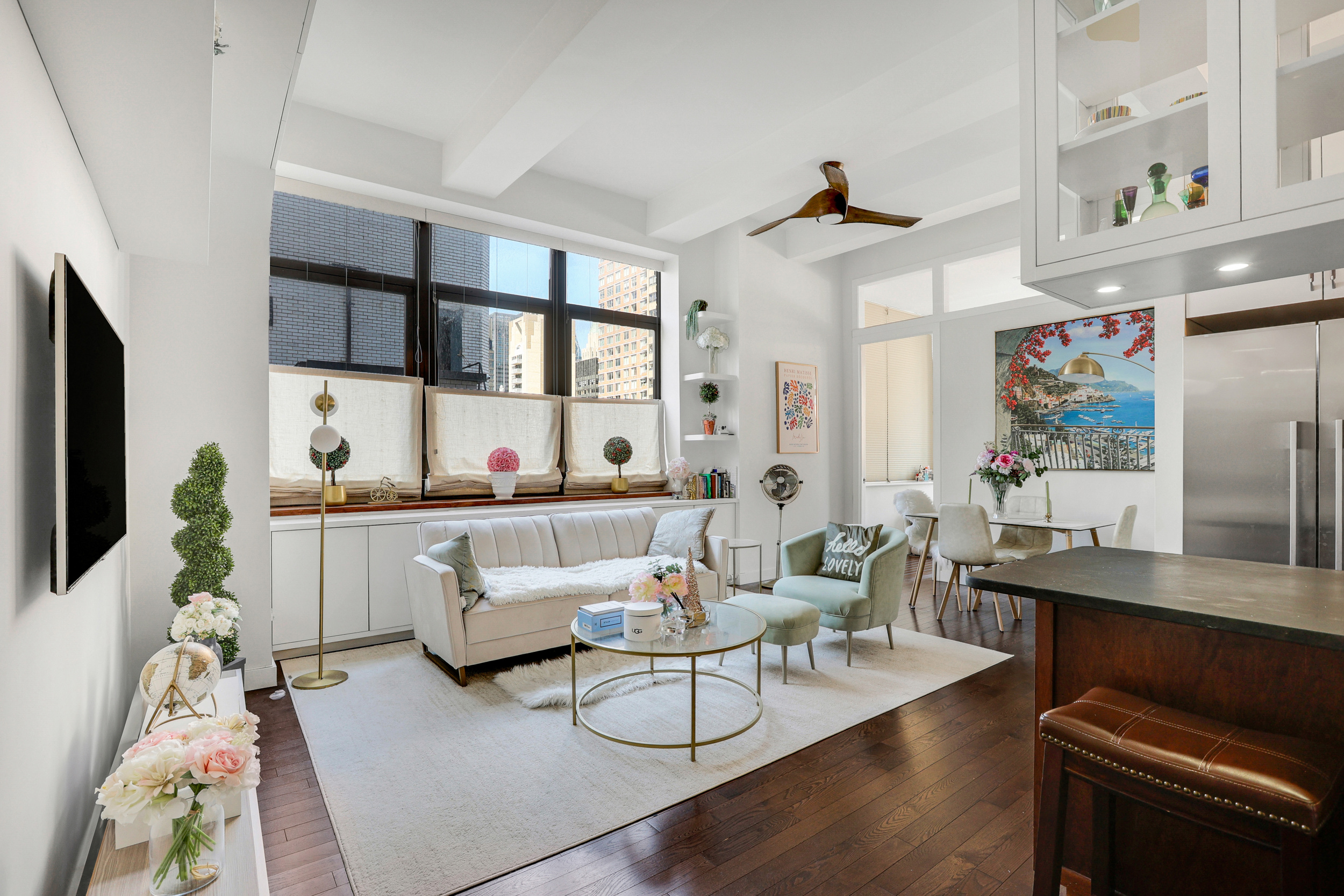 310 East 46th Street, Unit 16B Manhattan, NY 10017 - Photo 2 of 7 a living room with furniture and a flat screen tv