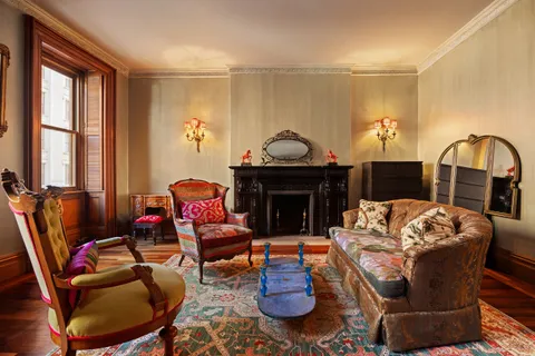 a living room with furniture a fireplace and a large window