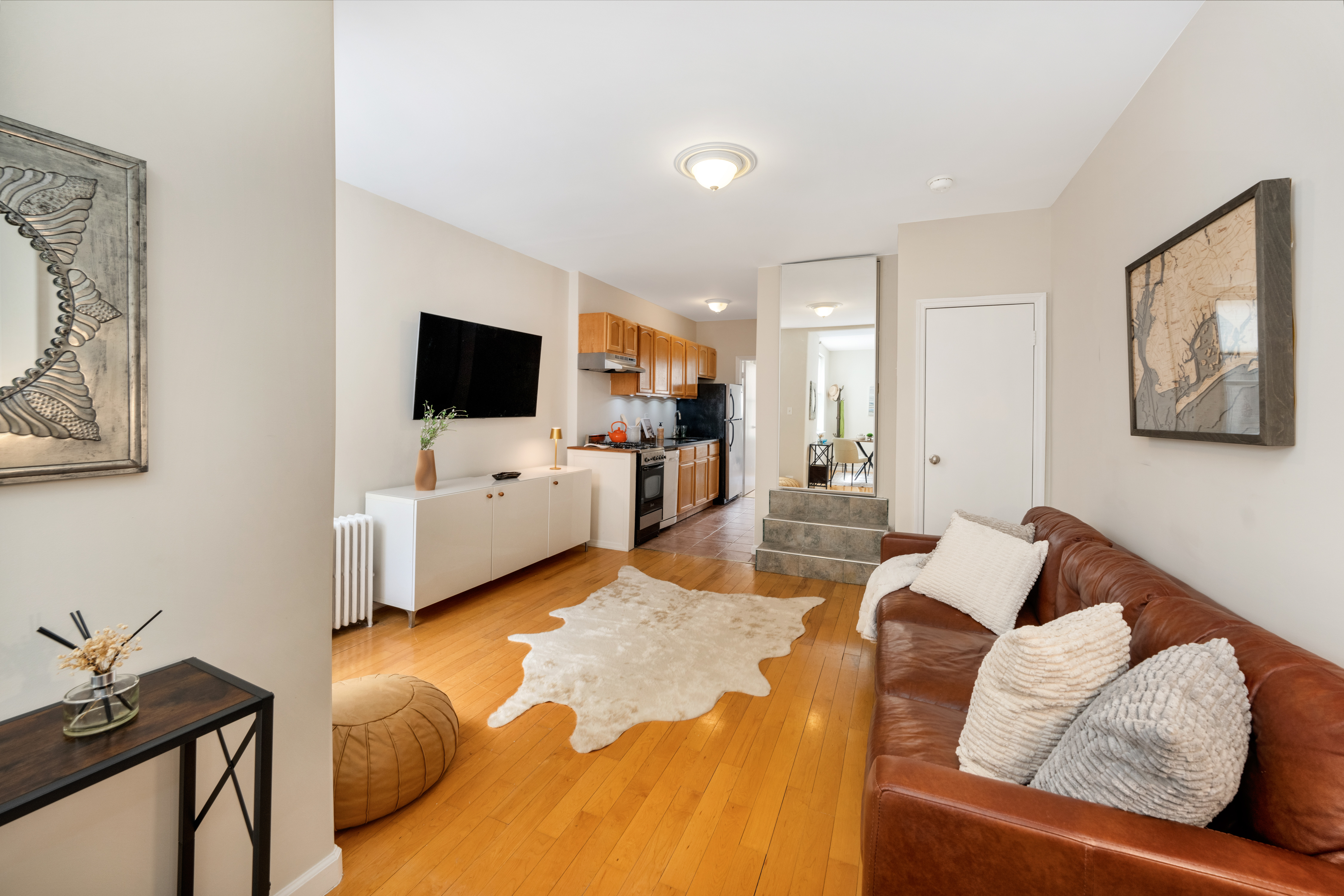 1286 Halsey Street, Unit 3B Brooklyn, NY 11237 - Photo 8 of 10 a living room with furniture and a flat screen tv