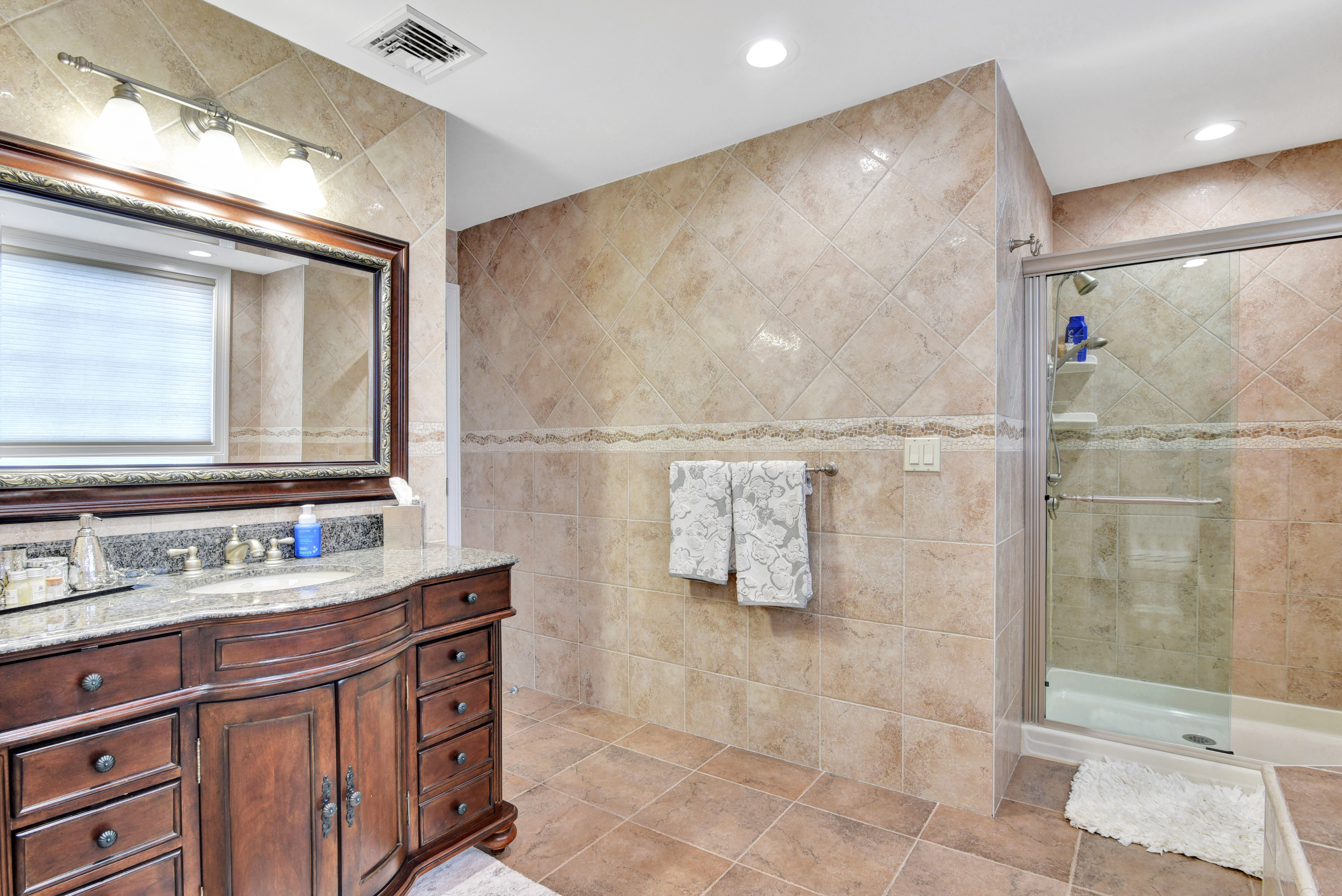 215 Lawrence Avenue Staten Island, NY 10310 - Photo 23 of 45 a bathroom with a double vanity sink mirror and shower