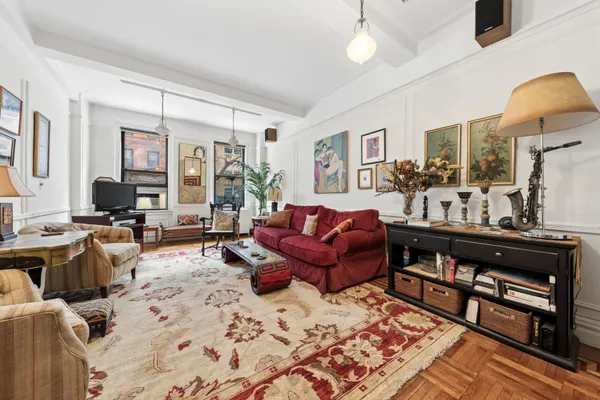 a living room with furniture a large window and a flat screen tv