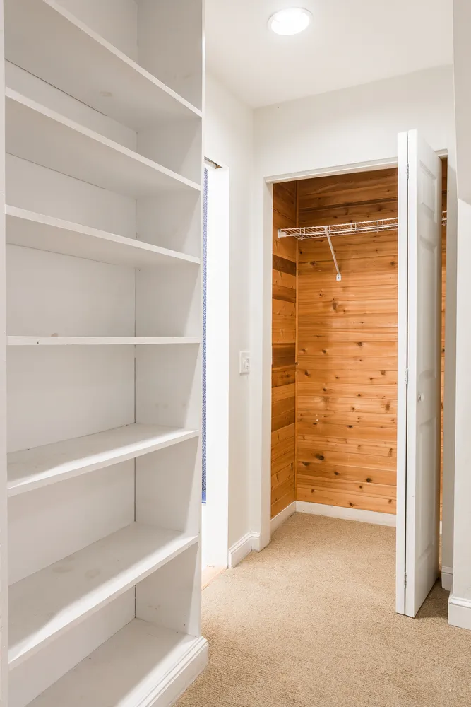 a view of an empty room with empty shelves