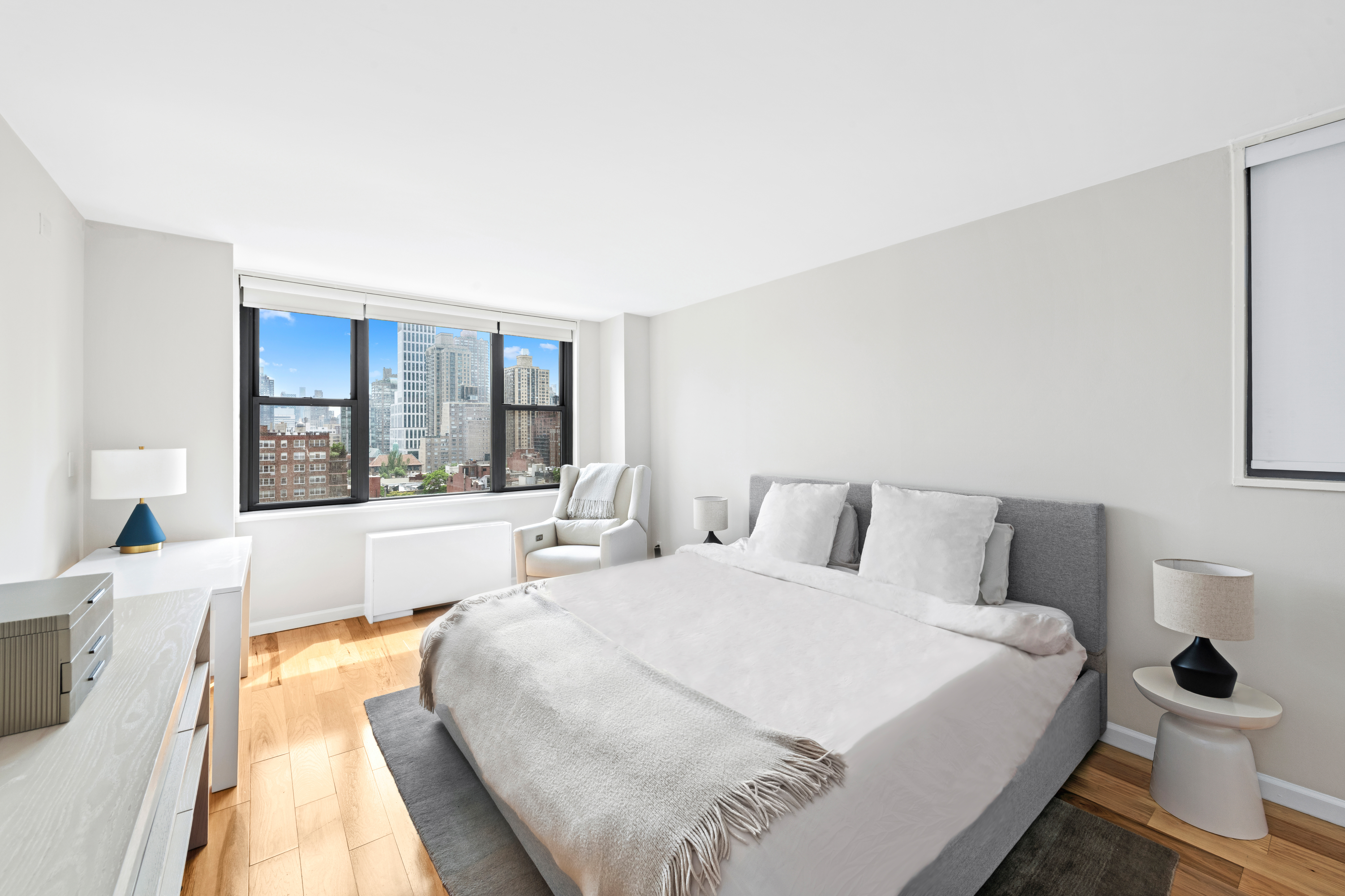 444 East 86th Street, Unit 16B Manhattan, NY 10028 - Photo 6 of 14 a bedroom with a large bed and a large window