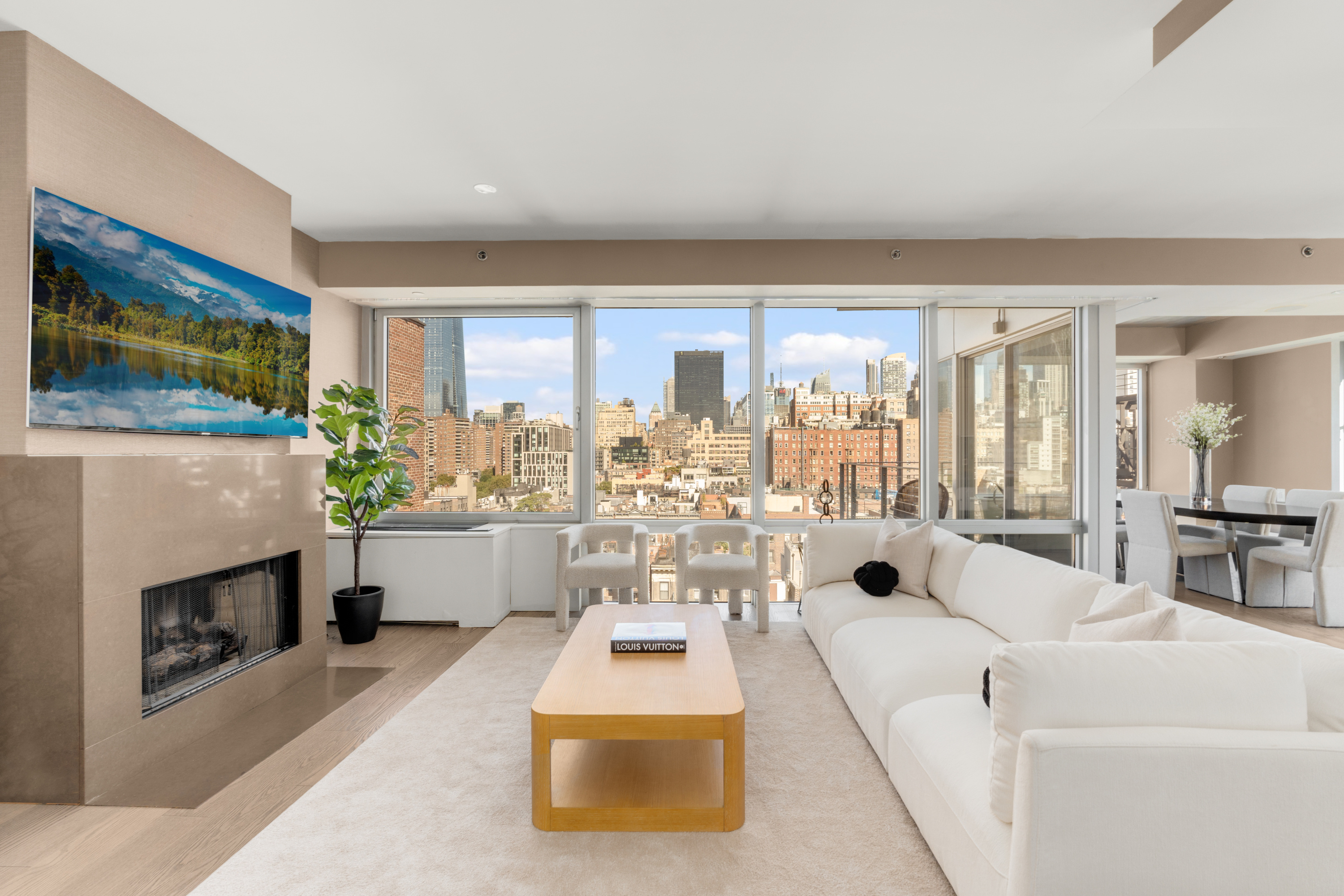 245 West 19th Street, Unit PH4 Manhattan, NY 10011 - Photo 2 of 10 a living room with furniture and a fireplace