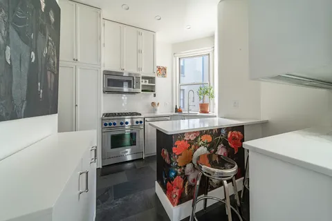 a kitchen with a stove and a refrigerator