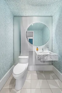 a bathroom with a toilet a sink and mirror