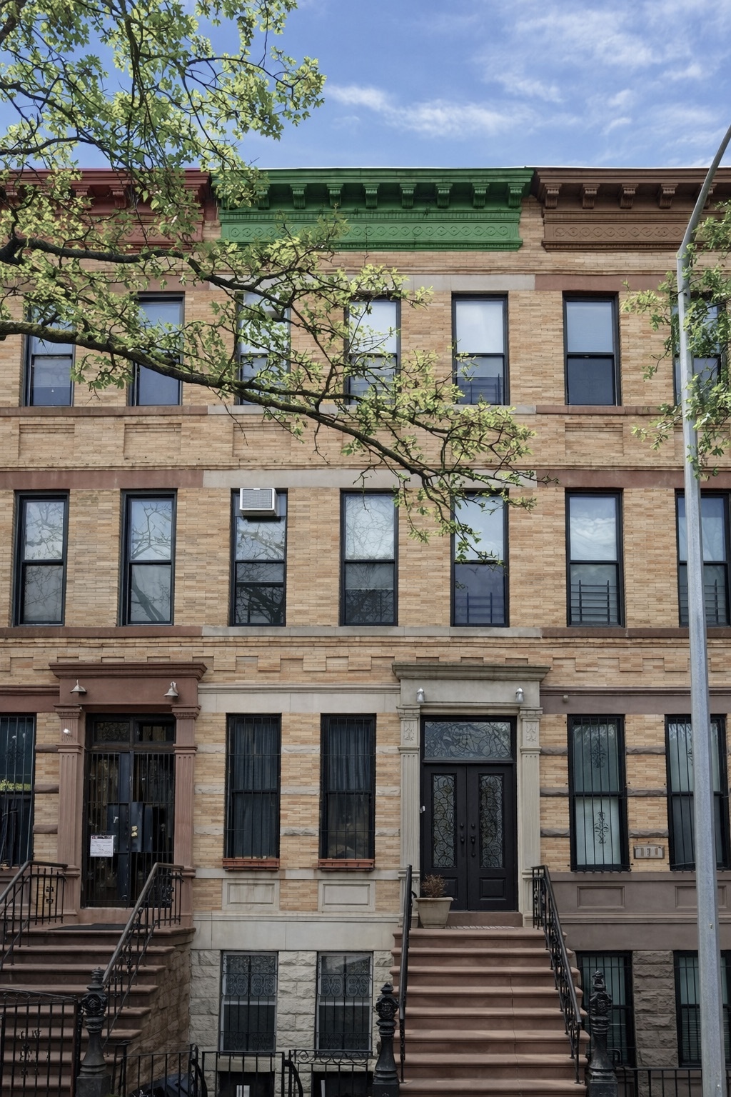 318 West 140th Street, Unit GARDEN Manhattan, NY 10030 - Photo 11 of 12 a front view of a house with a yard
