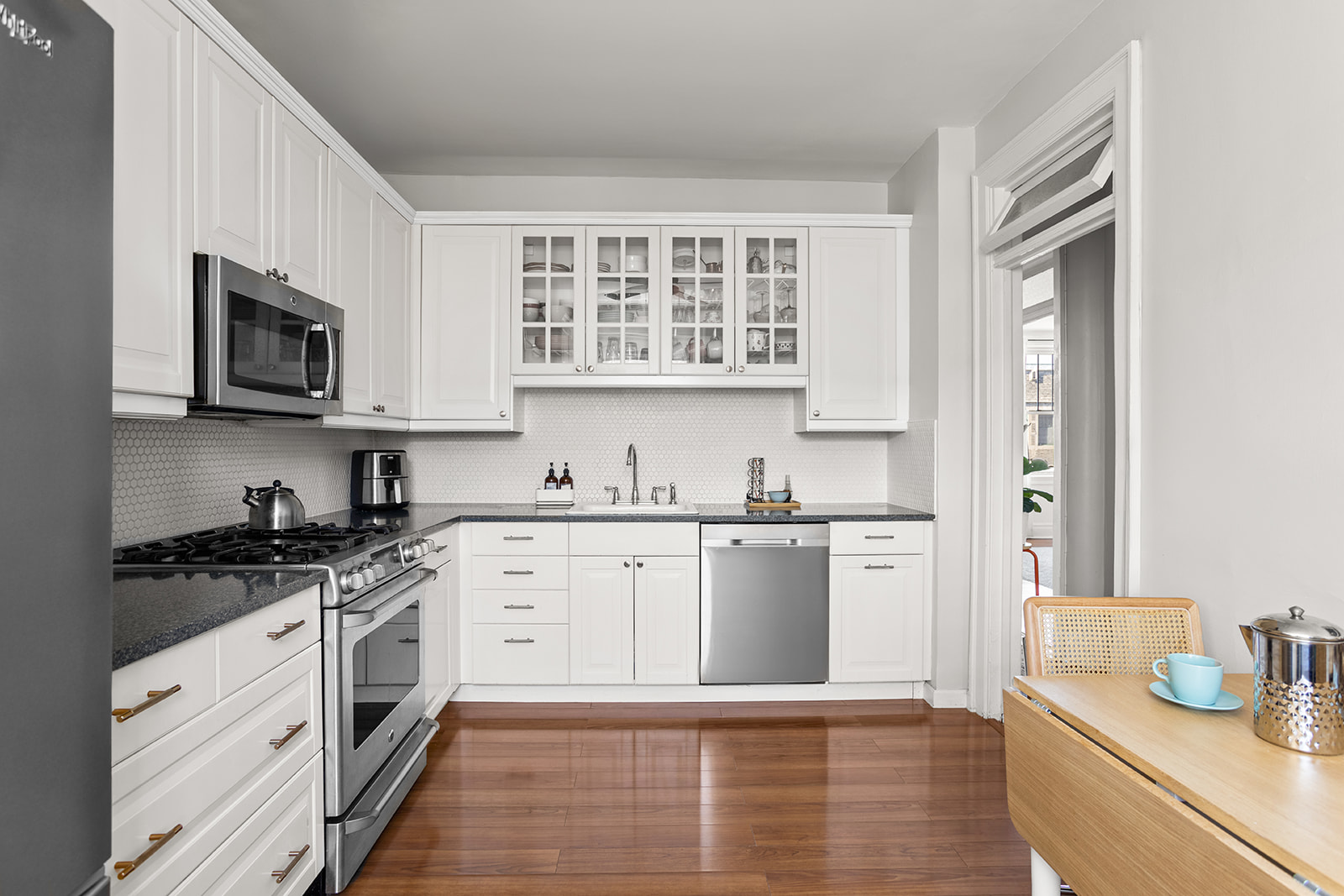35-21 80th Street, Unit 52A Queens, NY 11372 - Photo 5 of 11 a kitchen with stainless steel appliances granite countertop a stove a sink and a microwave