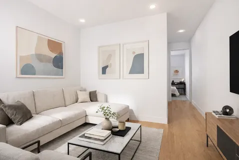a living room with furniture and wooden floor