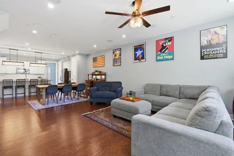 a living room with furniture and kitchen view