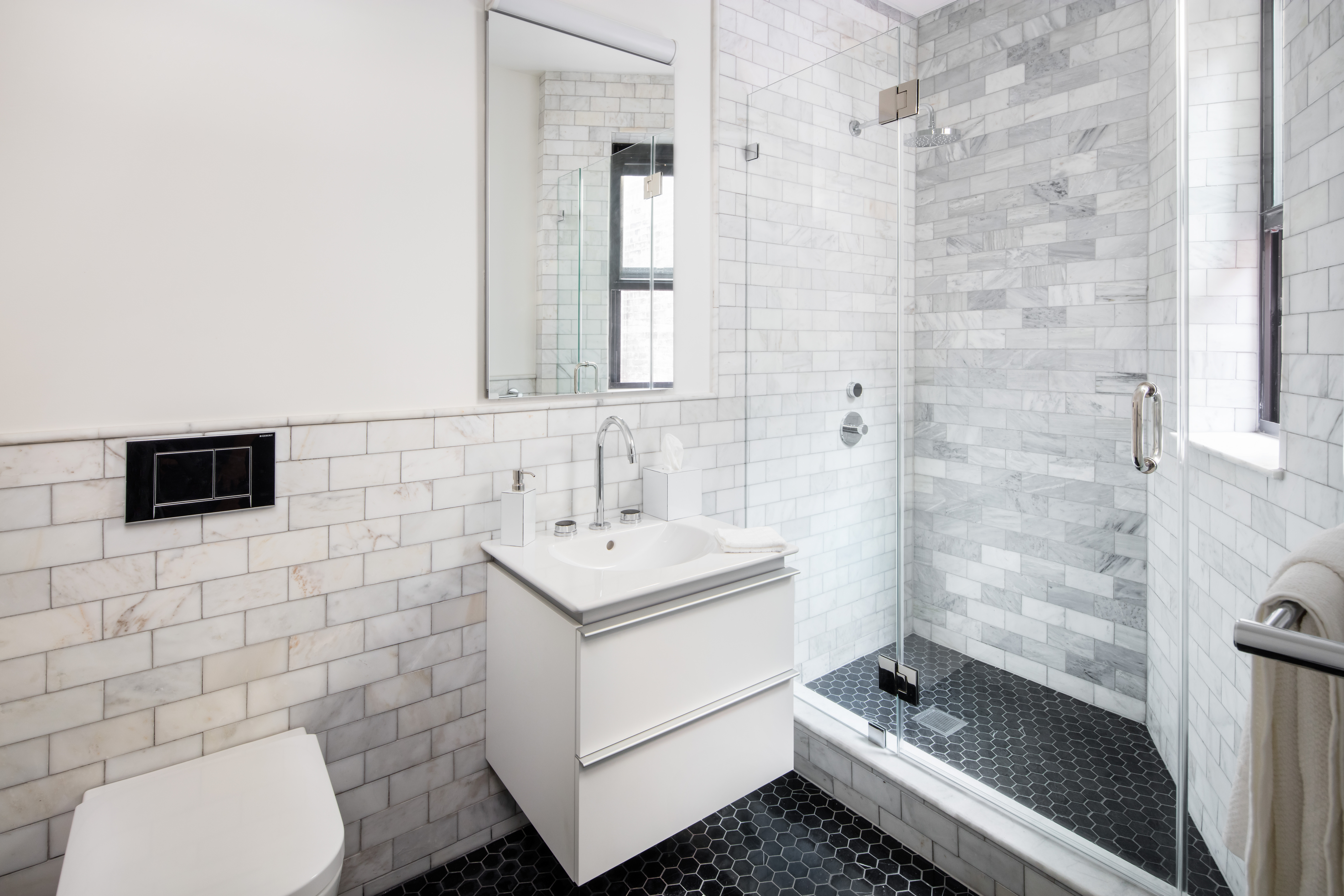 44 East End Avenue, Unit 3C Manhattan, NY 10028 - Photo 4 of 13 a bathroom with a sink a toilet and shower