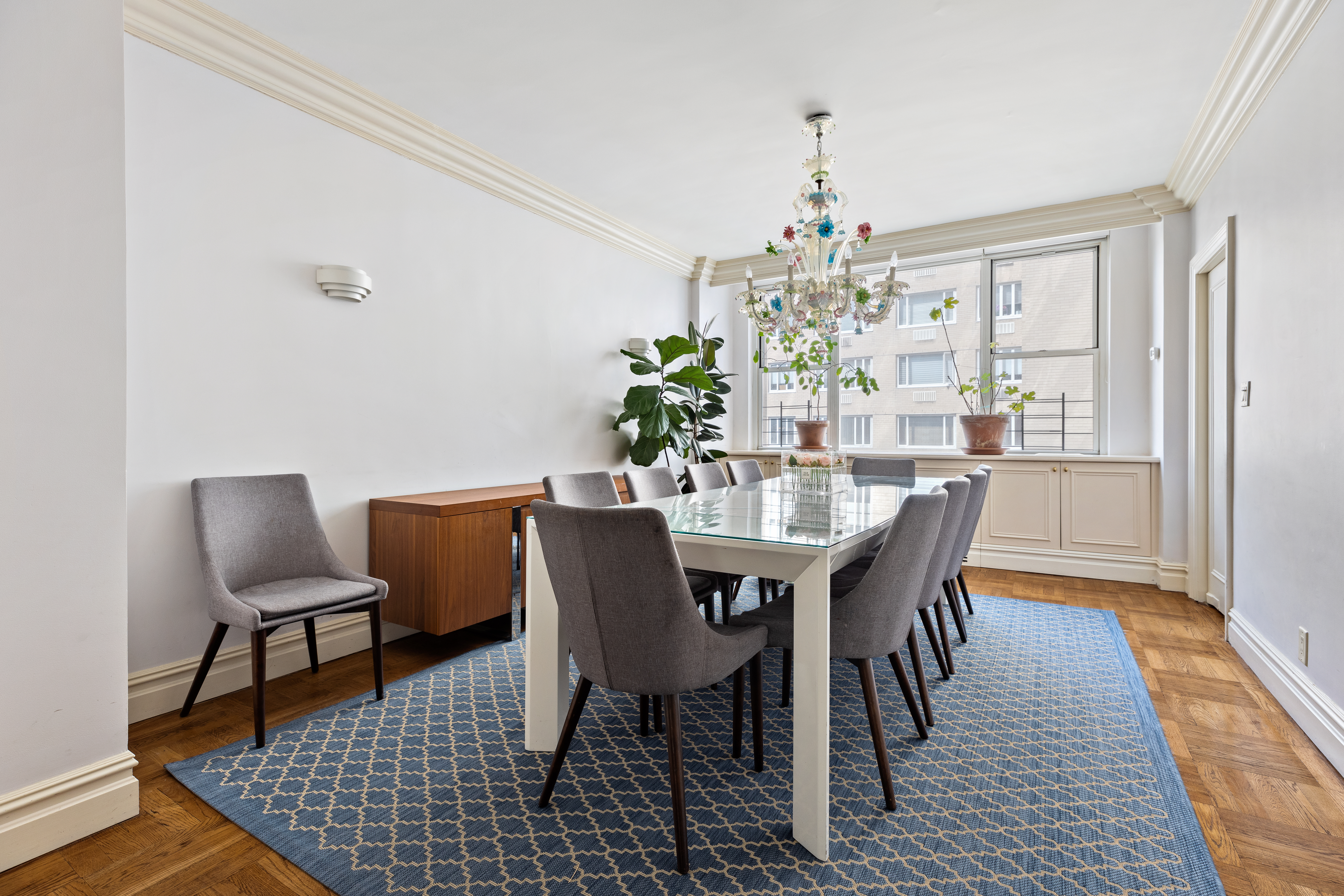 175 East 62nd Street, Unit 9D Manhattan, NY 10065 - Photo 5 of 12 a view of a dining room with furniture and wooden floor