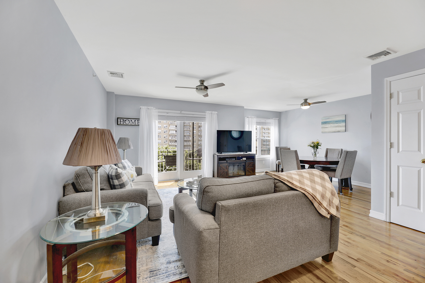 102-20 Rockaway Beach Boulevard, Unit 3C Queens, NY 11694 - Photo 8 of 36 a living room with furniture and a flat screen tv