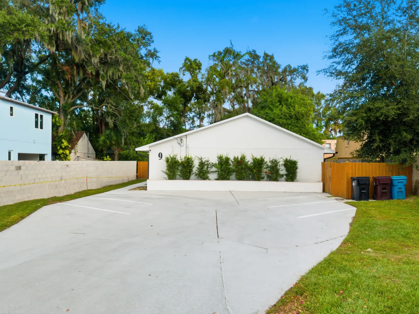 a white house with a large tree in front of it