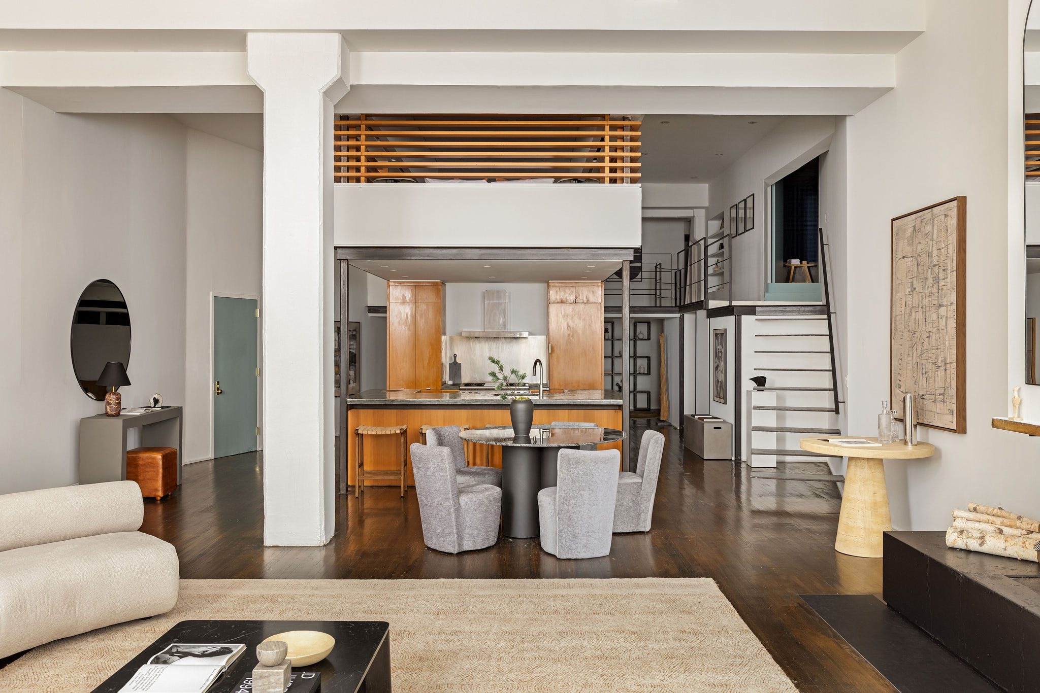 377 West 11th Street, Unit 1D Manhattan, NY 10014 - Photo 6 of 22 a living room with couches a dining table and chairs with wooden floor