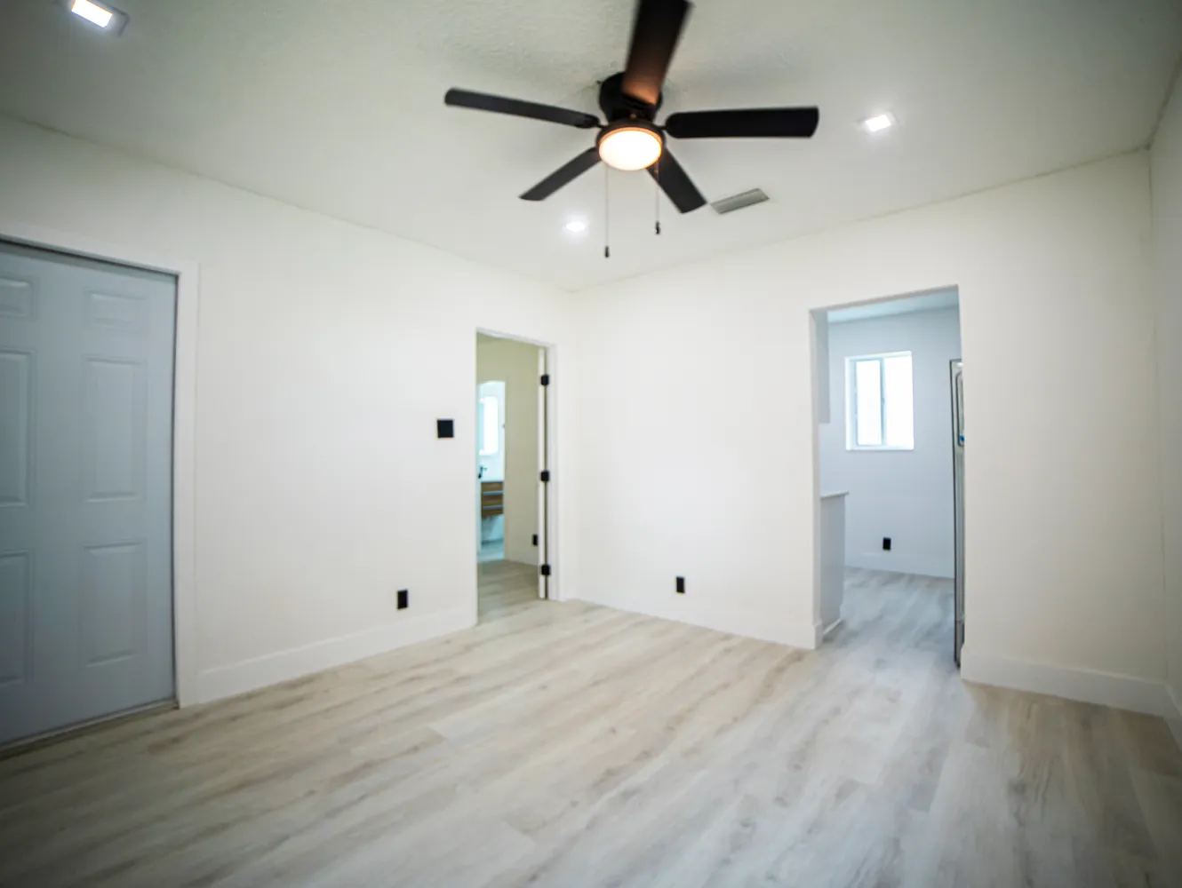an empty room with closet and windows
