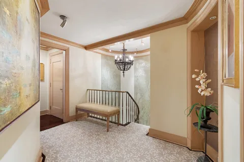 a view of a hallway with a bedroom and a window