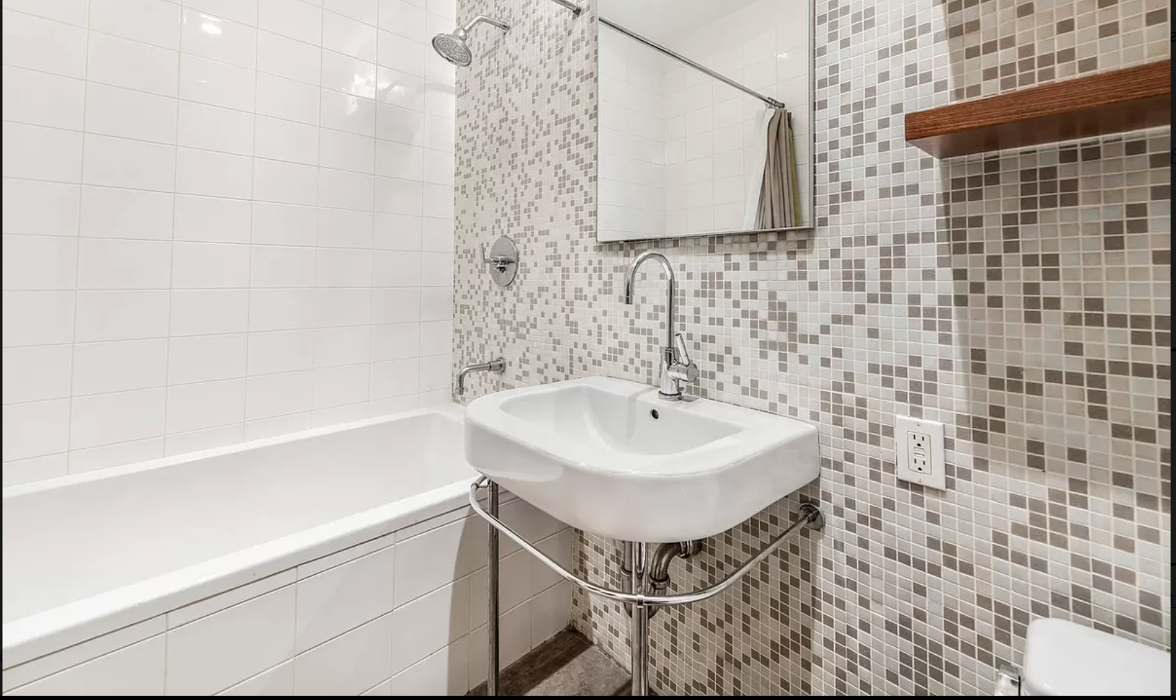 71 Nassau Street, Unit 12C Manhattan, NY 10038 - Photo 12 of 18 a bathroom with a sink a mirror and a shower