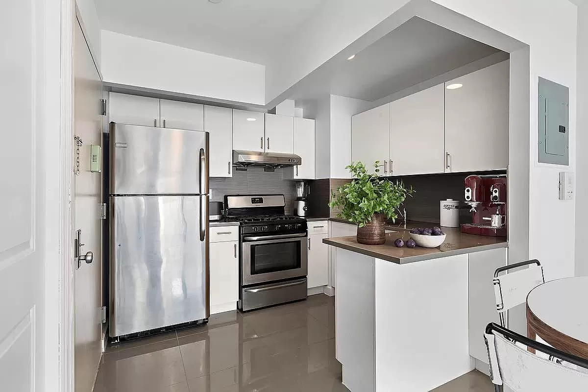 371 West 126th Street, Unit 5B Manhattan, NY 10027 - Photo 2 of 6 a kitchen with stainless steel appliances granite countertop a refrigerator sink and stove