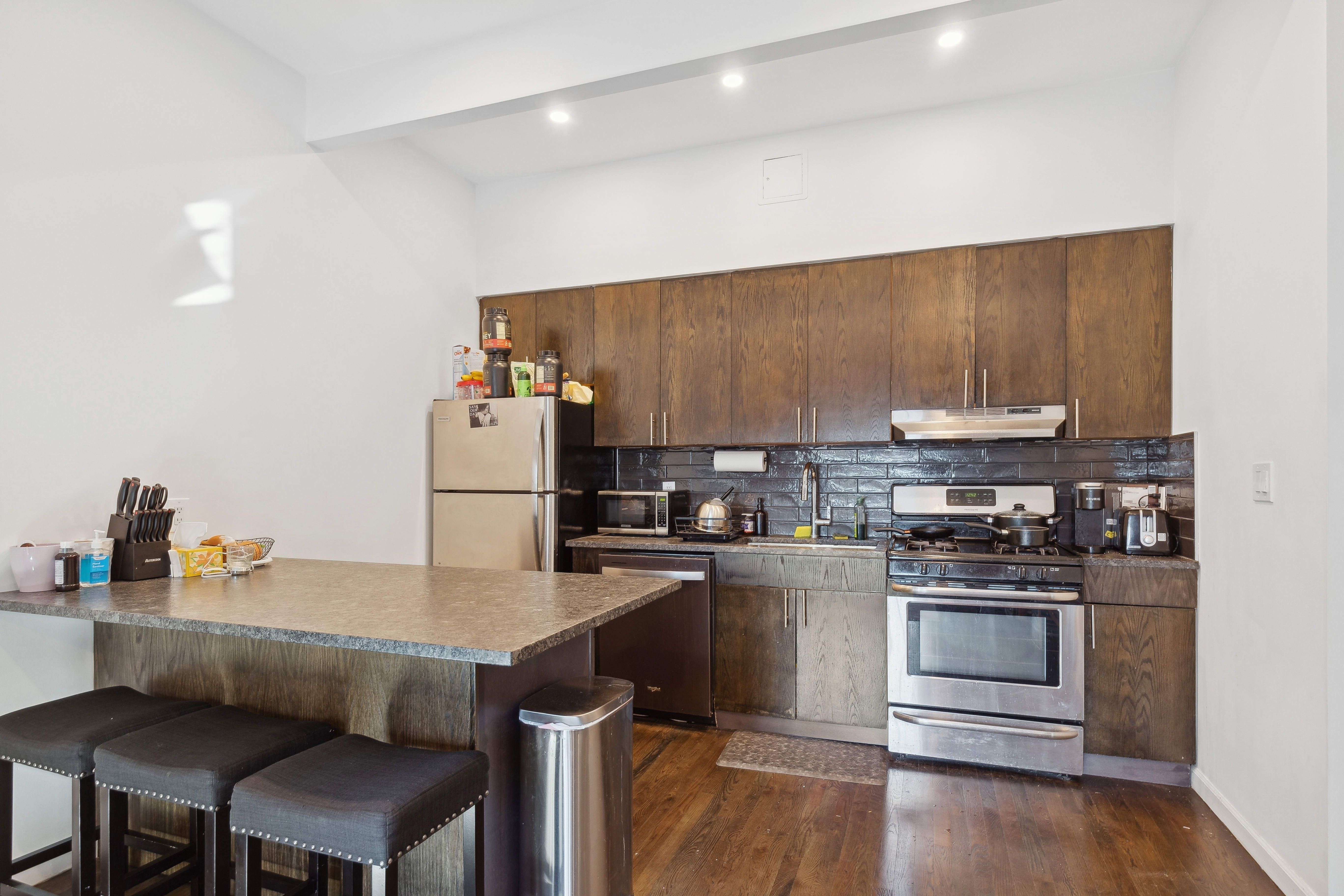131 North 6th Street, Unit 4 Brooklyn, NY 11249 - Photo 2 of 6 a kitchen with a sink cabinets and stainless steel appliances