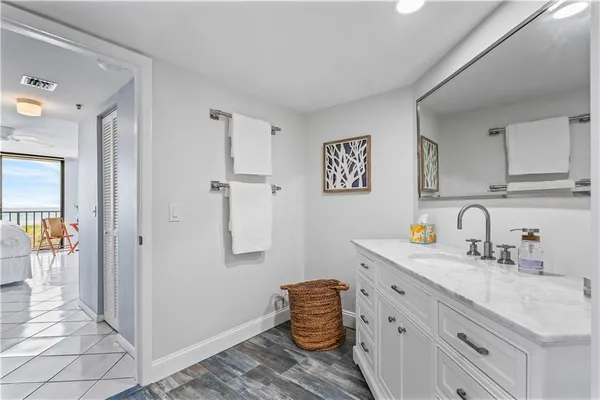 a kitchen with stainless steel appliances granite countertop a sink and dishwasher with white cabinets