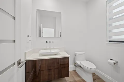 a kitchen with kitchen island a stove a refrigerator and a dining table