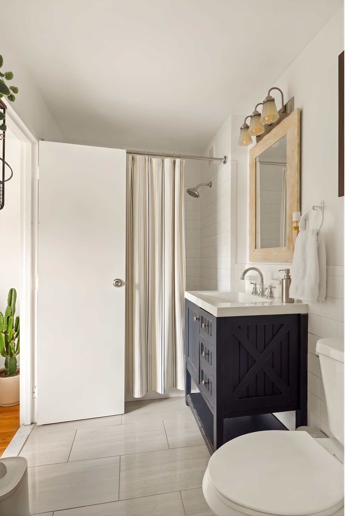 109 Pulaski Street Brooklyn, NY 11206 - Photo 8 of 14 a bathroom with a sink a toilet a mirror and shower curtain