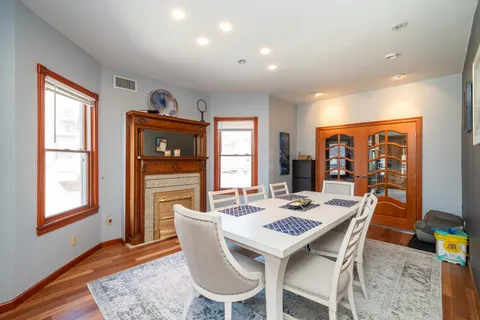 a dining room with furniture a rug and wooden floor