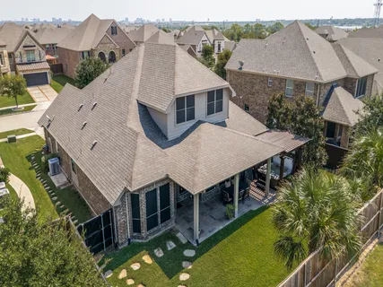an aerial view of a house with a big yard