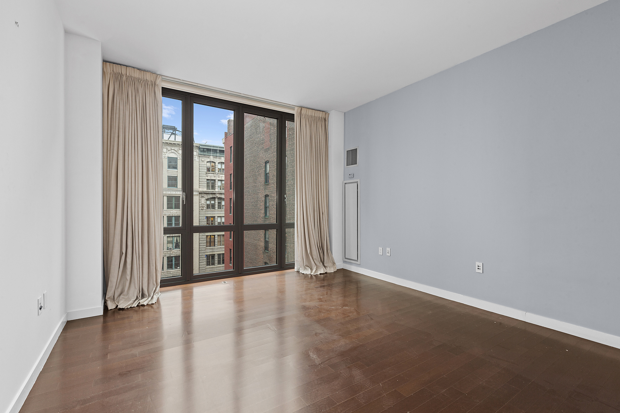 4 West 21st Street, Unit 11A Manhattan, NY 10010 - Photo 4 of 9 a view of an empty room with glass door
