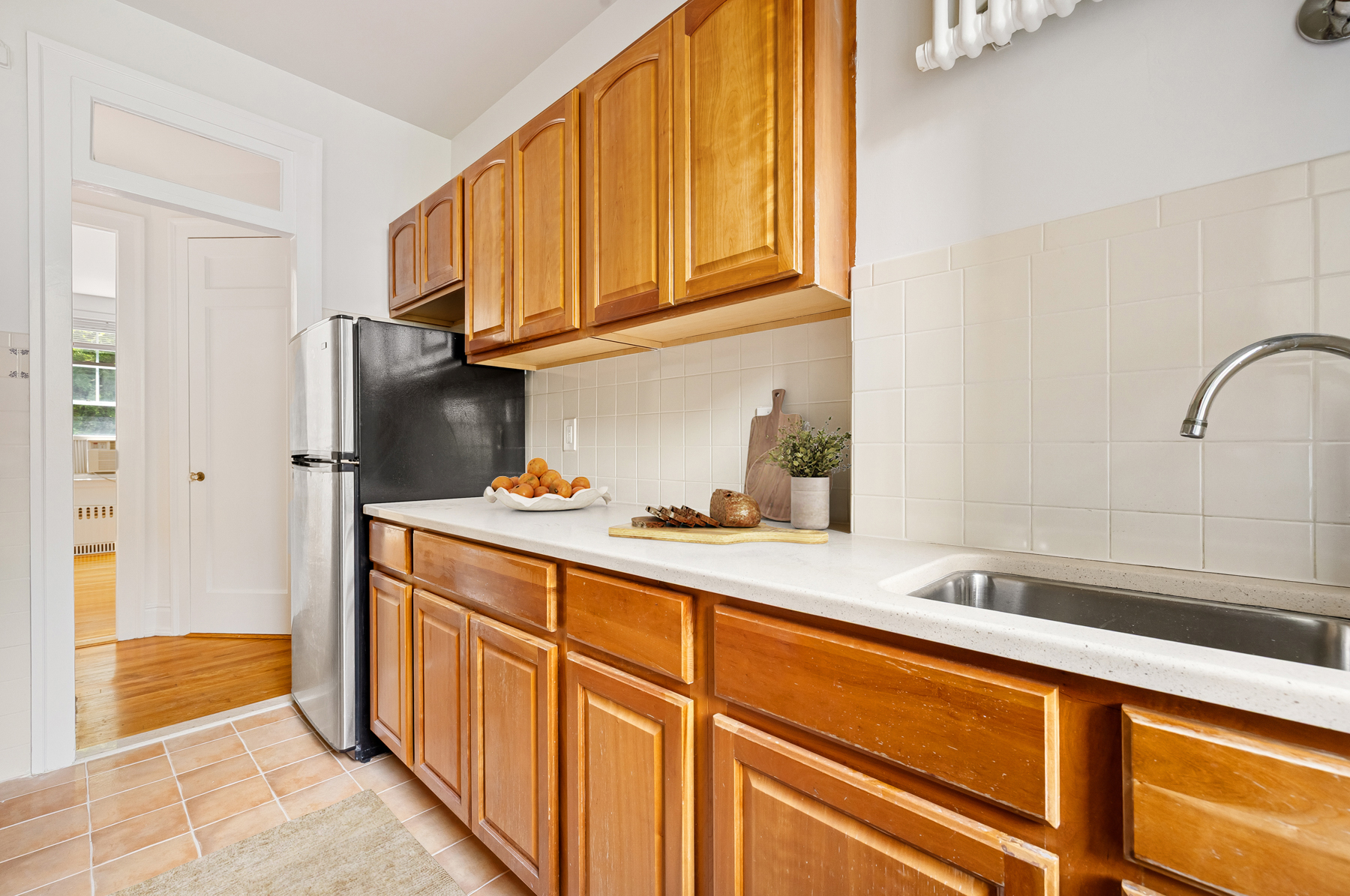 35-27 76th Street, Unit 21 Queens, NY 11372 - Photo 12 of 24 a kitchen with stainless steel appliances granite countertop a refrigerator and a sink