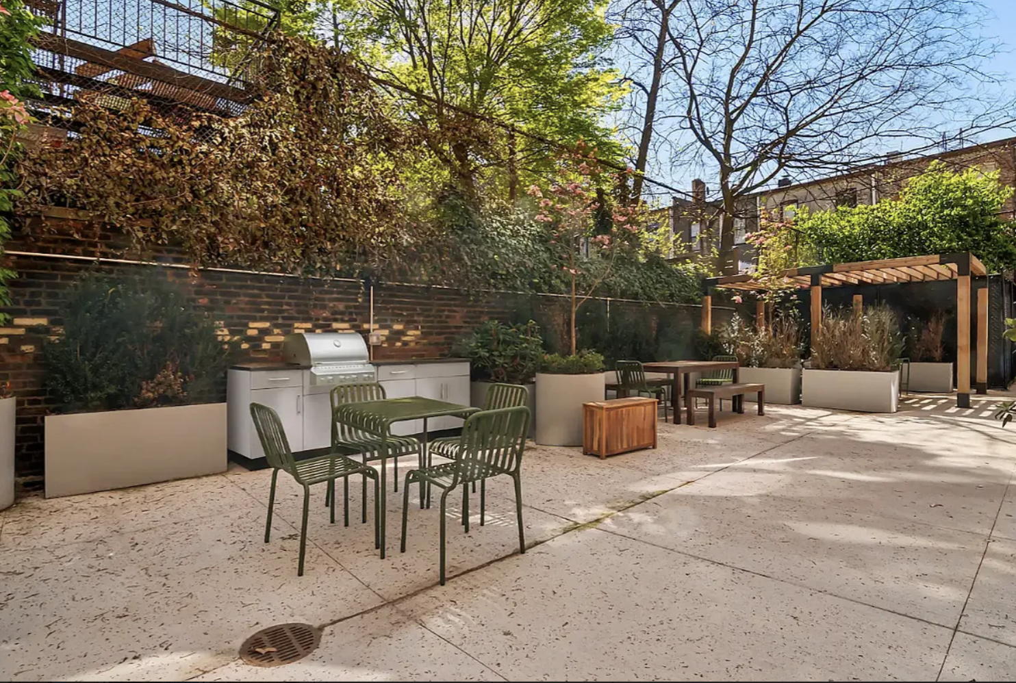 180 Bainbridge Street, Unit 304 Brooklyn, NY 11233 - Photo 7 of 21 a view of a patio with a dining table and chairs with a fire pit
