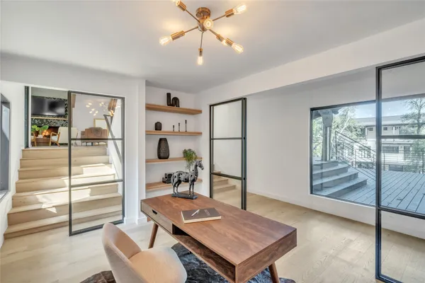 a living room with furniture a flat screen tv and a large window