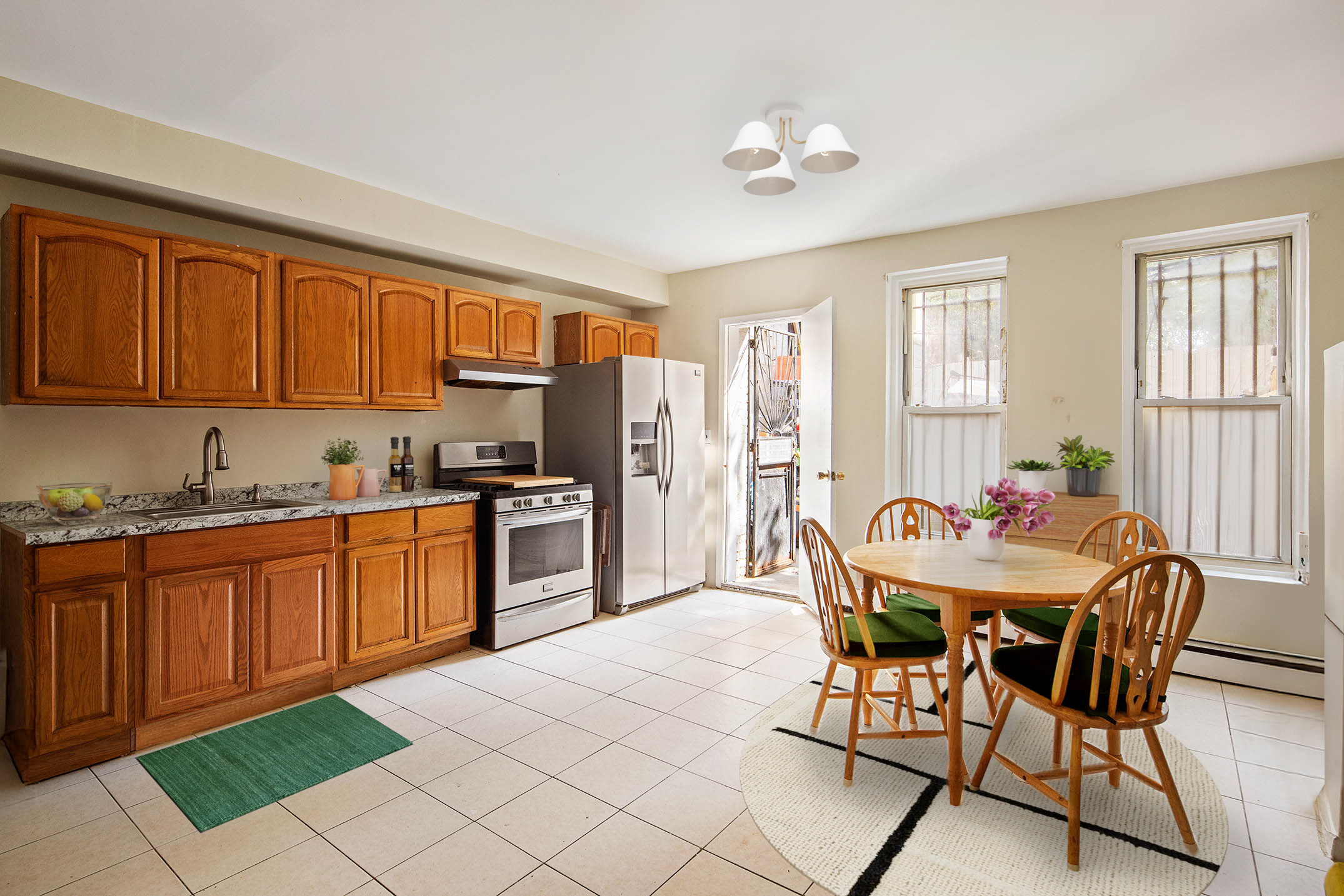 1008 Bushwick Avenue Brooklyn, NY 11221 - Photo 4 of 11 a kitchen with granite countertop a sink cabinets and stainless steel appliances