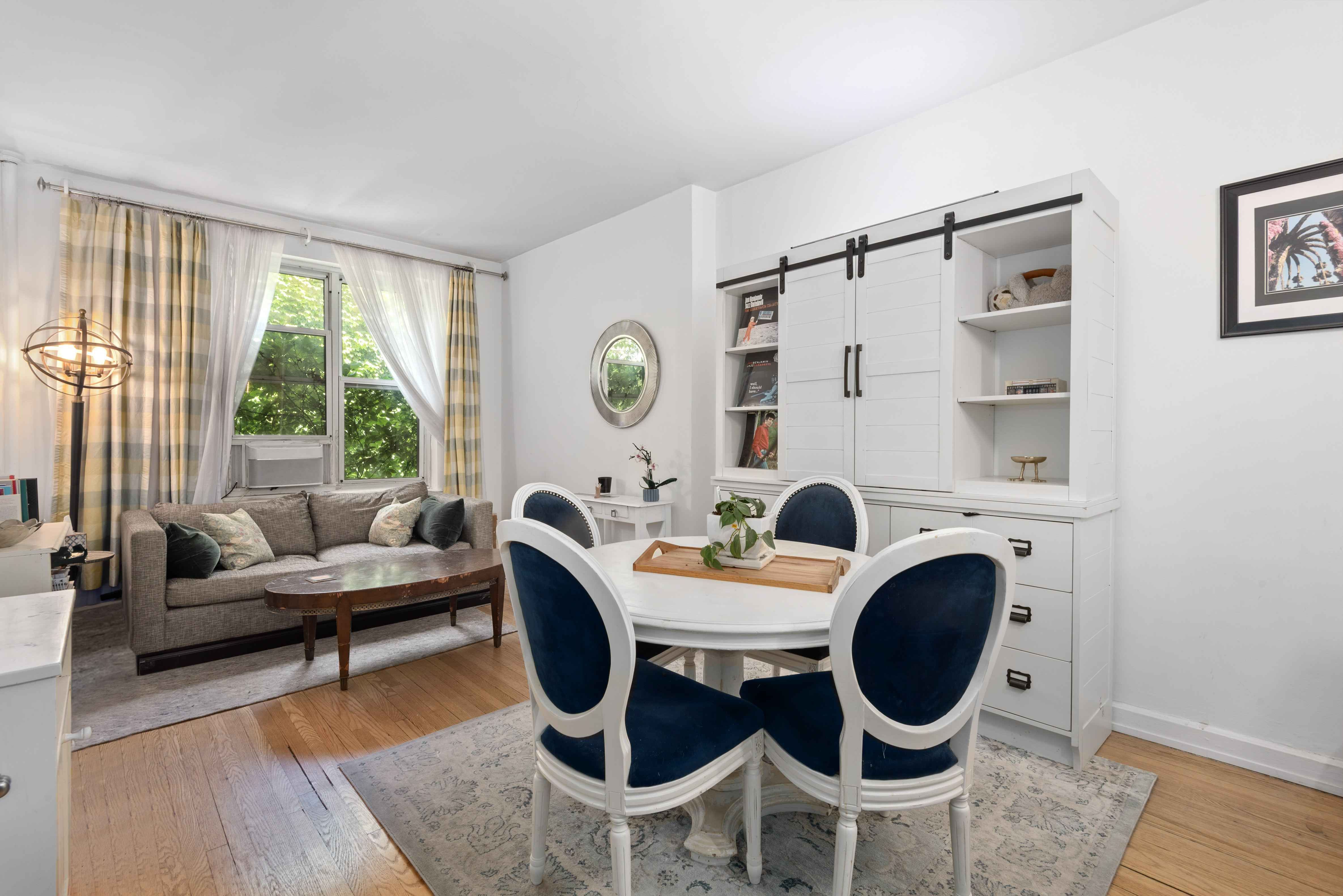 a view of a dining room with furniture window and wooden floor