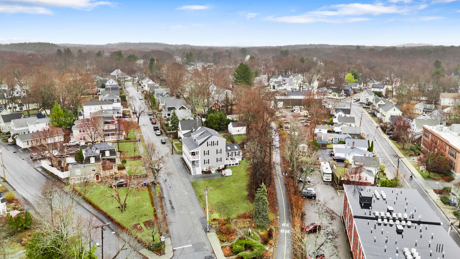 1 Maple Street, Unit 1 Maynard, MA 01754 - Photo 39 of 42 an aerial view of residential houses with outdoor space