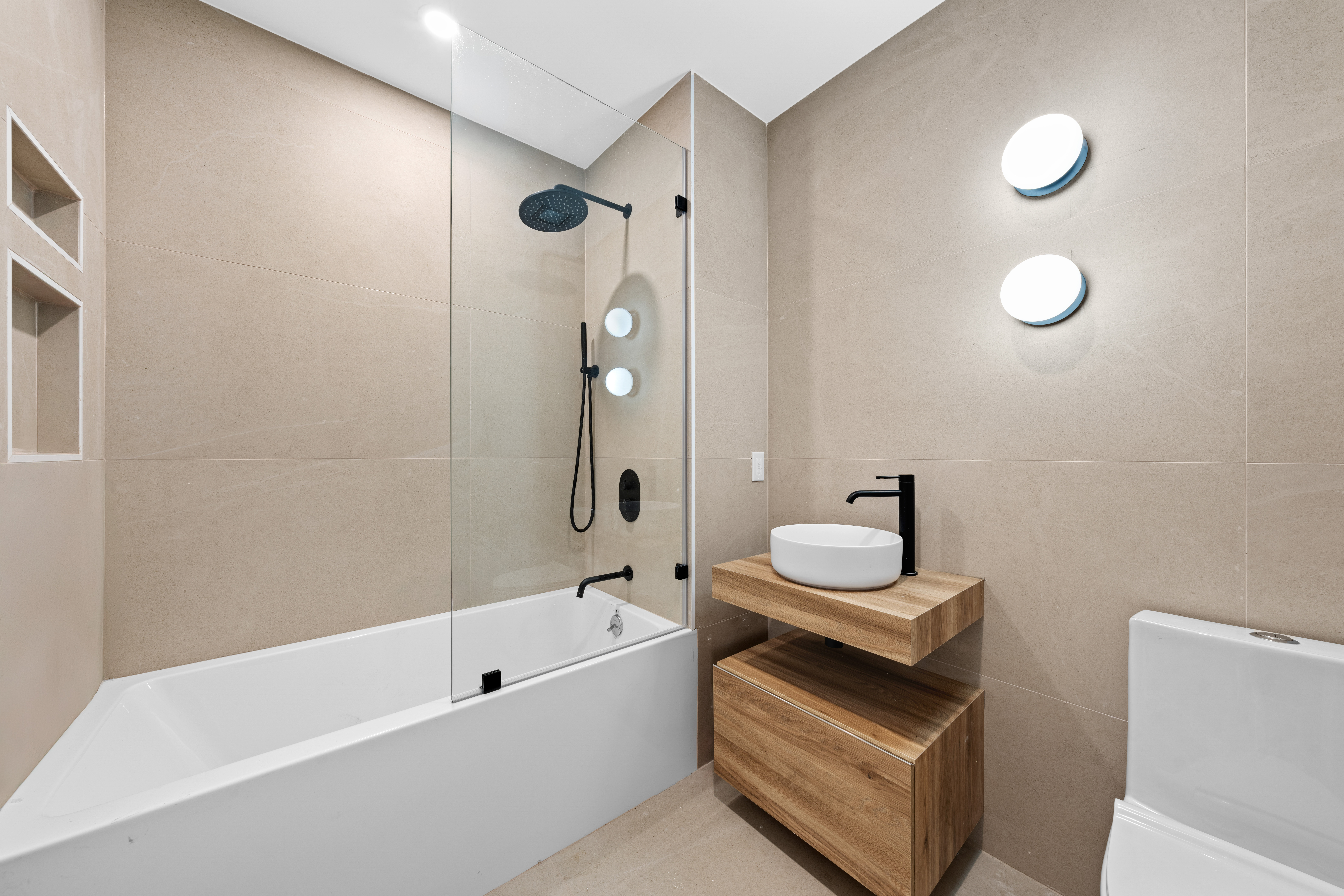 14-35 Broadway, Unit 1A Queens, NY 11106 - Photo 12 of 20 a bathroom with a sink toilet a shower and bathtub