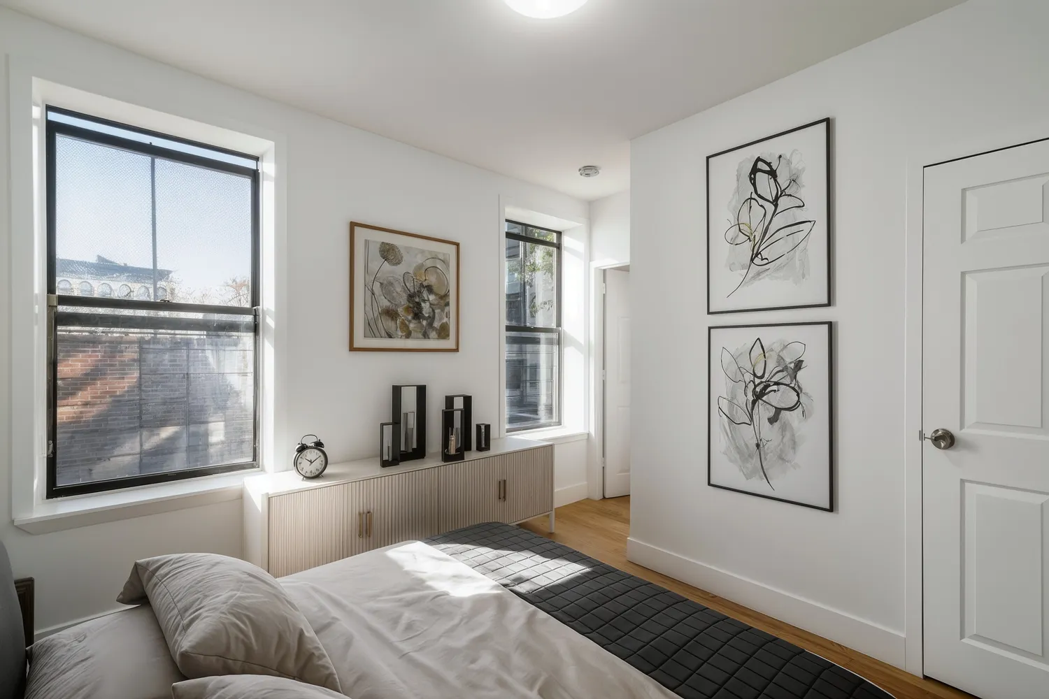 a bedroom with a large bed and glass window
